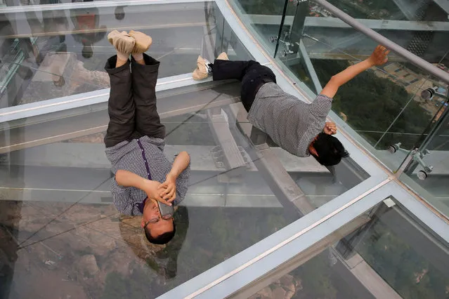 A man takes a selfie as he lies on the glass sightseeing platform on Shilin Gorge in Beijing, China, May 27, 2016. (Photo by Kim Kyung-Hoon/Reuters)