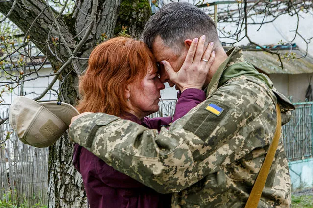 A woman reacts as she says goodbye to her serviceman husband before he leaves to the frontline, amid Russia's invasion, in Uzhhorod, Ukraine, April 26, 2022. (Photo by Serhii Hudak/Reuters)