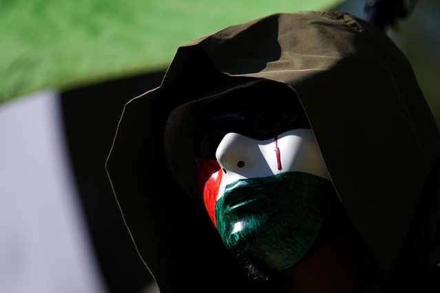 A protester waits at Union Park for the start of a march to the Democratic National Convention Monday, August 19, 2024, in Chicago. (Photo by Julio Cortez/AP Photo)