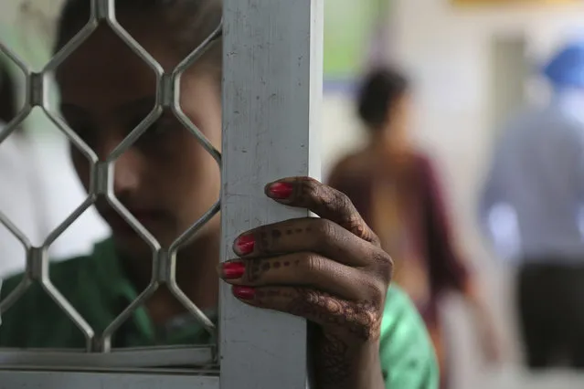 In this Thursday, October 31, 2019, photo, a recovering tramadol addict waits for her medication at a de-addiction center in Kapurthala, in the northern Indian state of Punjab. The pills were everywhere, as legitimate medication sold in pharmacies, but also illicit counterfeits hawked by itinerant peddlers and street vendors. India has twice the global average of illicit opiate consumption. Researchers estimate about 4 million Indians use heroin or other opioids, and a quarter of them live in the Punjab, India's agricultural heartland bordering Pakistan. (Photo by Channi Anand/AP Photo)