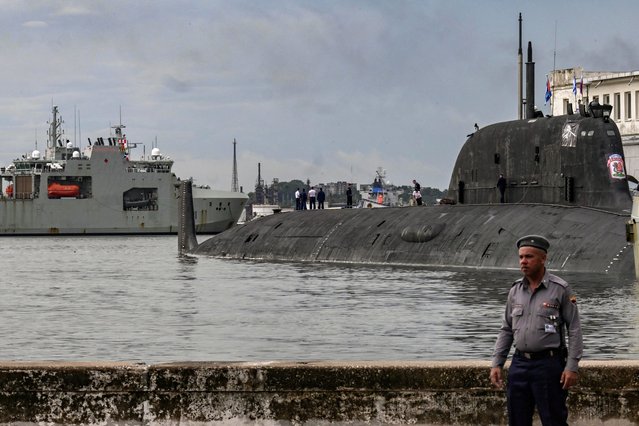 Russian Marines standing on top of the Russian nuclear-powered submarine Kazan (R), part of the Russian naval detachment visiting Cuba, watch Canada's HMCS Margaret Brooke, the second Harry DeWolf-class offshore patrol vessel for the Royal Canadian Navy (RCN), upon arrival in Havana Harbor on June 14, 2024. The visit of the Canadian warship is to celebrate 80 years of relations between Cuba and Canada and coincides with the presence of a Russian naval force docked in the same port. (Photo by Yamil Lage/AFP Photo)