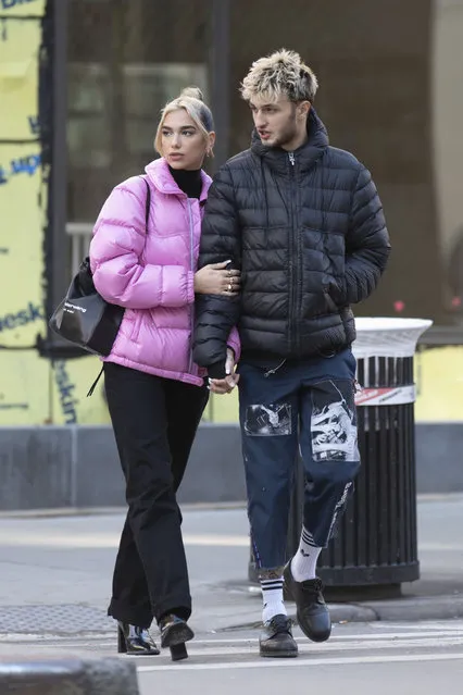Dua Lipa and Anwar Hadid head out together holding hands in New York on December 20, 2019. The couple headed to Anwar's sister Gigi's nearby home where they appeared to tour the apartment for half an hour before heading back. Before going inside pop star Dua took time to sign autographs for fans waiting outside. (Photo by Splash News and Pictures)