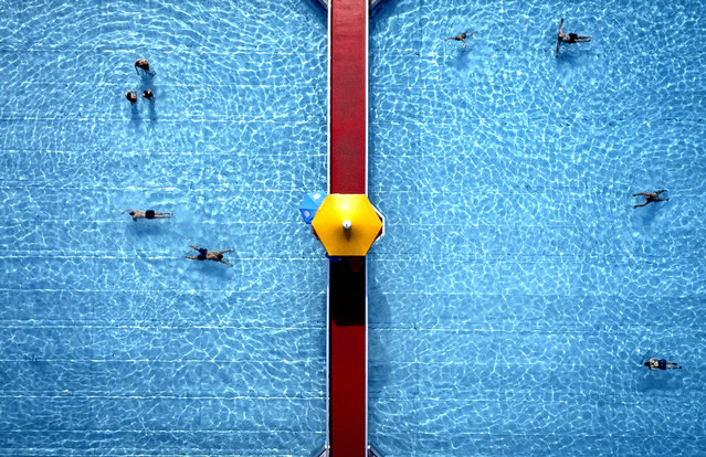 People swim in a public pool in Frankfurt, Germany, on a warm Tuesday, September 3, 2024. (Photo by Michael Probst/AP Photo)