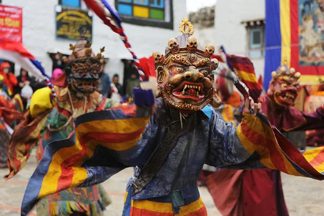 Elaborately dressed monks costumed as wrathful guardian spirits perform ceremonial dances during the Tenchi Festival on May 25, 2014 in Lo Manthang, Nepal. The Tenchi Festival takes place annually in Lo Manthang, the capital of Upper Mustang and the former Tibetan Kingdom of Lo. Each spring, monks perform ceremonies, rites, and dances during the Tenchi Festival to dispel evils and demons from the former kingdom. (Photo by Taylor Weidman/Getty Images)