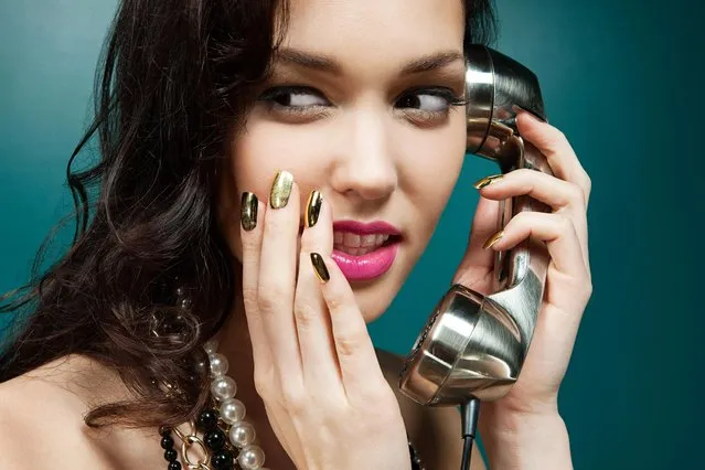 Young woman using vintage telephone. (Photo by Image Source/Getty Images)