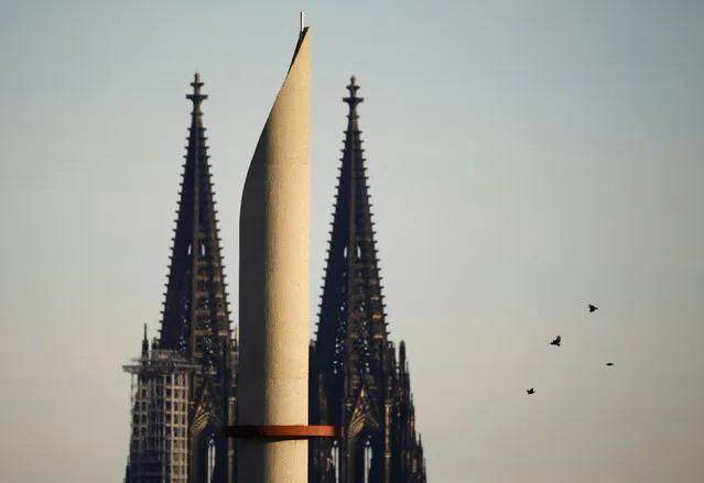 One of the two 55m high minarettes of the new Cologne Central Mosque that is still under construction is seen behind to the famous landmark and UNESCO world heritage, the Cologne Cathedral in Germany, January 25, 2016. (Photo by Wolfgang Rattay/Reuters)
