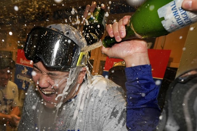 Los Angeles Dodgers Shohei Ohtani celebrates in the locker room after their win against the New York Mets in Game 6 of a baseball NL Championship Series, Sunday, October 20, 2024, in Los Angeles. (Photo by Ashley Landis/AP Photo)