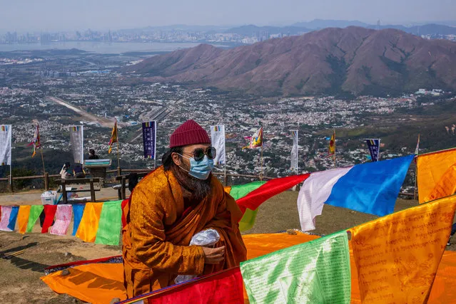 A celebrant takes part in the ninth Hong Kong Buddha Sunning Festival at the Tai Mo Shan lookout on February 18, 2020 in Hong Kong, China. The global death toll from the coronavirus epidemic rose above 200, with all but five of those and the vast majority of the more-than 75,000 cases occurring on mainland China. (Photo by Billy H.C. Kwok/Getty Images)