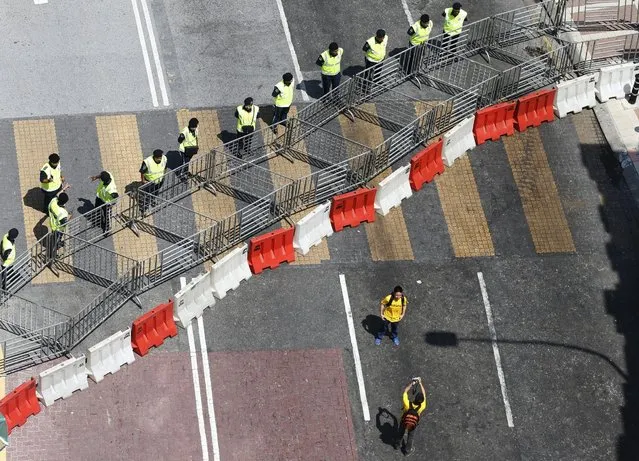 Protesters take photos in front of police barricades ahead of a rally organised by pro-democracy group “Bersih” (Clean) in Malaysia's capital city of Kuala Lumpur, August 29, 2015. (Photo by Olivia Harris/Reuters)