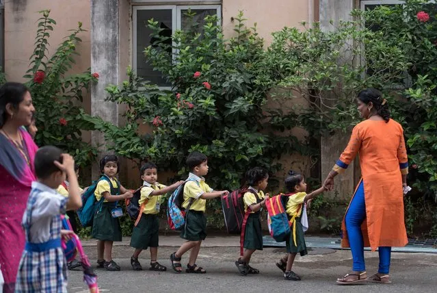 Children enjoy first day of the school at Mahila Sangh School, Vile Parle, on June 15, 2017 in Mumbai, India. Attired in brand-new uniforms, the children turned up at their respective schools after a long summer vacation. (Photo by Satish Bate/Hindustan Times via Getty Images)