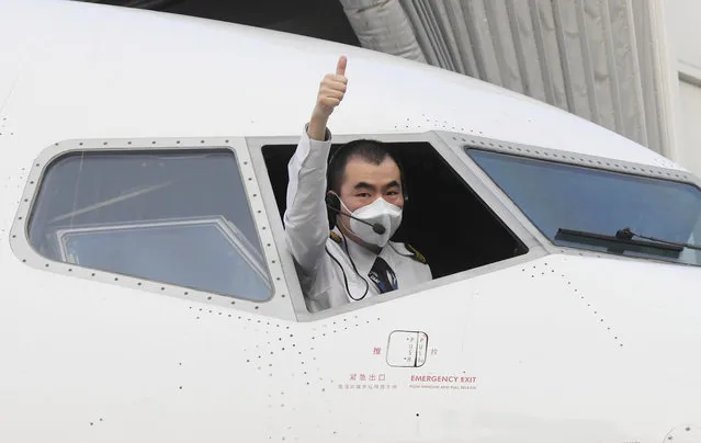 Pilot of flight MU2527 of China Eastern airlines gestures before takeoff at the Tianhe International Airport in Wuhan, central China's Hubei Province, April 8, 2020. Wuhan on Wednesday lifted outbound travel restrictions, after almost 11 weeks of lockdown to stem the spread of COVID-19. (Photo by Cheng Min/Xinhua News Agency)