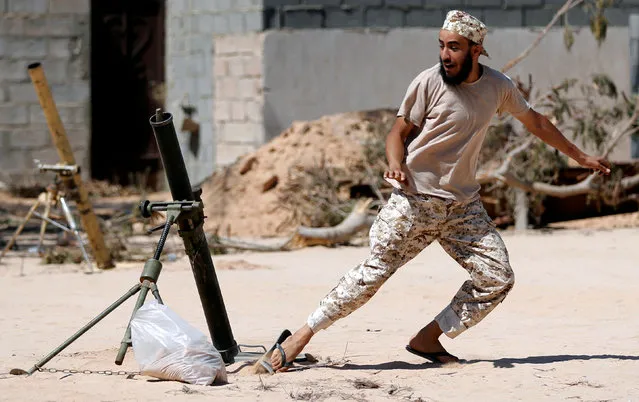 A fighter of Libyan forces allied with the U.N.-backed government fires a 81 mm mortar round in Sirte, Libya, July 25, 2016. (Photo by Goran Tomasevic/Reuters)
