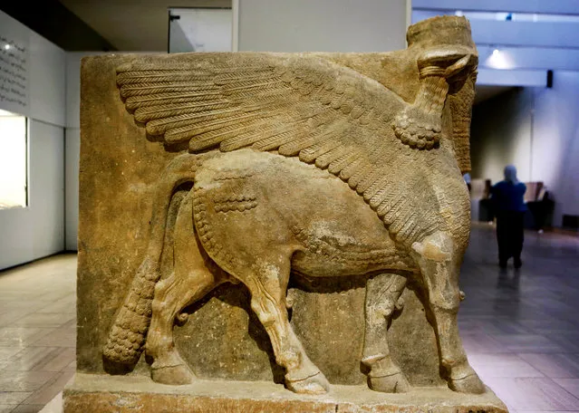 This Monday, September 15, 2014 photo shows a winged bull made out of limestone displayed at the Iraqi National Museum in Baghdad. Now much of that archaeological wealth is under the control of extremists from the Islamic State group. They have already destroyed some of that heritage in their zealotry to uproot what they see as heresy. Antiquities officials in Iraq and Syria warn of a disaster as the region's history is erased. (Photo by Hadi Mizban/AP Photo)