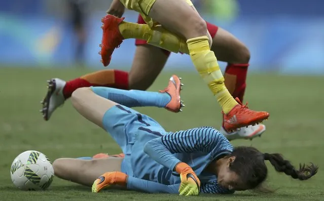 2016 Rio Olympics, Soccer, Preliminary, Women's First Round, Group E China vs Sweden, Mane Garrincha Stadium, Brasilia, Brazil on August 9, 2016. Goalkeeper Lina Zhao (CHN)  of China makes a save in traffic against Sweden. (Photo by Ueslei Marcelino/Reuters)