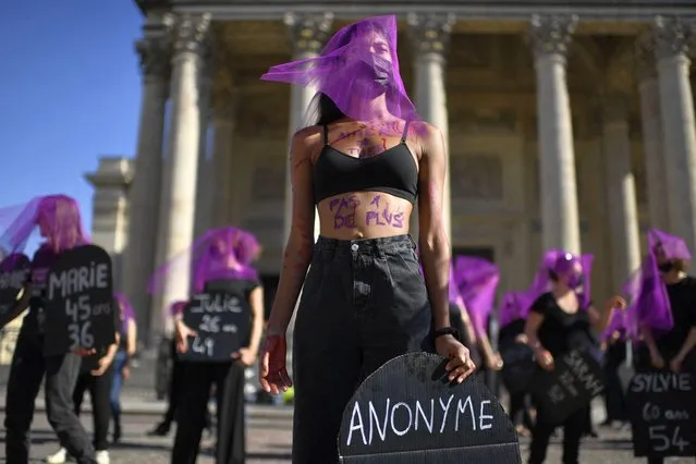 Women activists wearing veils gather at during a rally organised by the collective #NousToutes against feminicides at Place du Pantheon in Paris on October 9, 2022. (Photo by Julien de Rosa/AFP Photo)