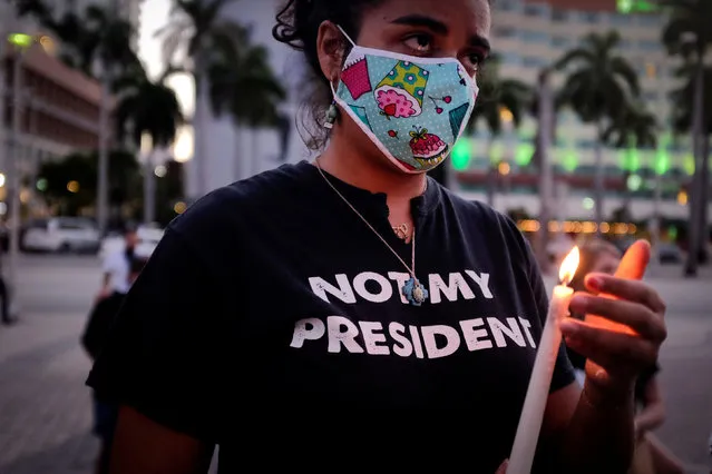 A woman holds a candle as she attends a vigil for slain black activist Oluwatoyin Salau, in Downtown Miami, Florida, U.S., June 16, 2020. (Photo by Marco Bello/Reuters)