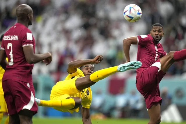 Ecuador's Felix Torres, center, duels for the ball with Qatar's Abdulaziz Hatem, right, during the World Cup, group A soccer match between Qatar and Ecuador at the Al Bayt Stadium in Al Khor, Sunday, November 20, 2022. (Photo by Ariel Schalit/AP Photo)