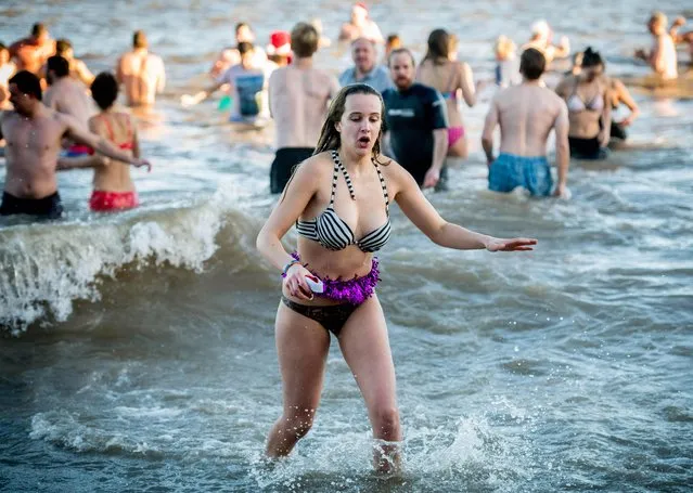 Around 300 brave swimmers take part in Cromer's annual Boxing Day Dip in the North Sea on December 26, 2017 in Cromer, England. People gather with many in costume to dip into the North Sea off the Norfolk coast on the Boxing Day annual event which has taken place since 1985 to raise money for the Stroke Association charity. (Photo by Andrew Parsons)