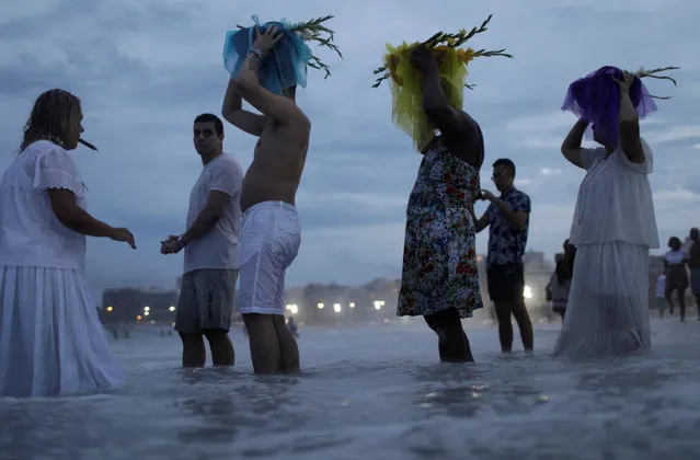 Followers of the Afro-Brazilian religion Umbanda pay tribute to Iemanja, goddess of the sea, in Copacabana Beach in Rio de Janeiro, Brazil December 29, 2017. (Photo by Ricardo Moraes/Reuters)
