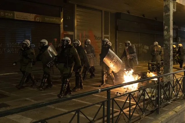 Riot police secure the area during a protest rally following the death of a teenager, in Athens, on Tuesday, December 13, 2022. (Photo by Yorgos Karahalis/AP Photo)