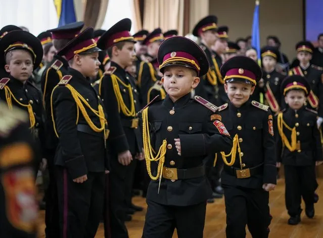 Young military cadets take part in a ceremony of receiving their shoulder marks, amid Russia's attack on Ukraine, in Kyiv, Ukraine on November 18, 2022. (Photo by Gleb Garanich/Reuters)