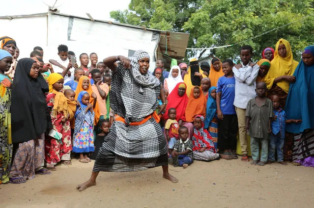 A woman dances on the last day of week-long wedding celebrations for newly married Somali couple Mohamed Noor and Huda Omar in Mogadishu's Rajo camp, Somalia August 24, 2016. (Photo by Feisal Omar/Reuters)