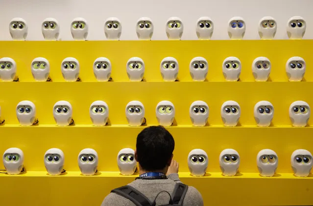 An attendee looks at book reading robots called Luka at CES International Tuesday, January 9, 2018, in Las Vegas. (Photo by Jae C. Hong/AP Photo)