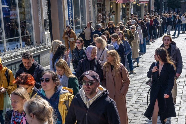Russians queue to cast their votes in front of the Russian consulate at Istiklal Avenue in Istanbul on March 17, 2024, during Russia's presidential election. Russians vote on the final day of an election to extend Vladimir Putin's rule to three decades, as Ukraine launched fatal attacks on the border and some voters spoiled their ballots in protest. (Photo by Bulent Kilic/AFP)