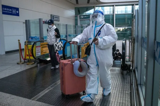 A traveler in protective gear at a train station in Beijing, China, on Wednesday, December 21, 2022. China's broad budget deficit hit a record so far this year, showing how damaging the now abandoned Covid Zero policy and the ongoing housing slump have been to the economy and to the government's finances. (Photo by Bloomberg/Getty Images)