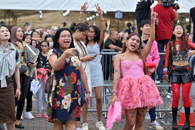 Taylor Swift's fans, or Swifties, sing and dance to her music at the National Stadium for Swift's Eras Tour concert in Singapore on March 2, 2024. (Photo by Caroline Chia/Reuters)