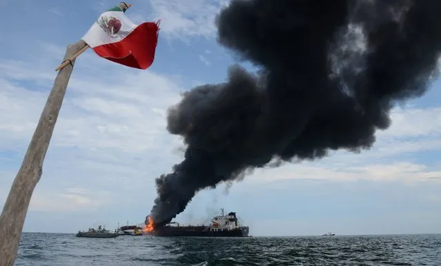 Smoke rises from the ship “Burgos” owned by state-run company Pemex, where an explosion occured, close to coast of the port of Veracruz, Mexico, 24 September 2016. The ship was loaded with 80,000 barrels of diesel and 16,000 barrels of gasoline. (Photo by Luis Monroy/EPA)