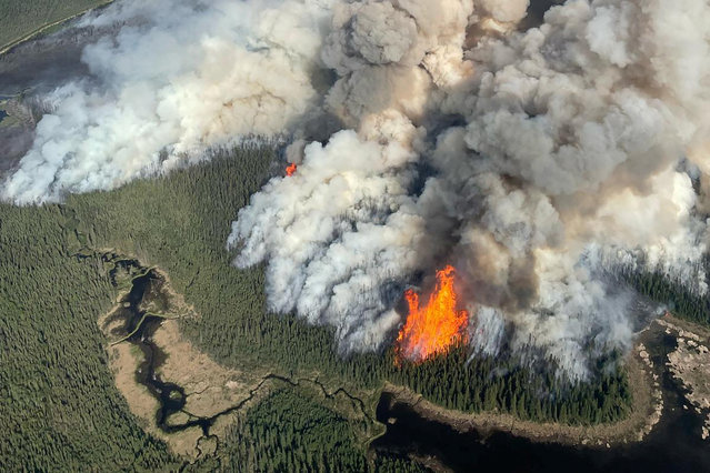 Smoke rises from the Kiskatinaw River wildfire (G70422) during a planned ignition operation, south of Dawson Creek, British Columbia, Canada on June 7, 2025. (Photo by BC Wildfire/Handout via Reuters)