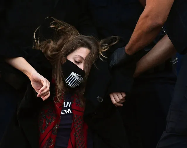 A protester is removed from demonstrations during the confirmation hearings for Supreme Court Justice nominee Amy Coney Barrett in Washington, District of Columbia, USA on October 15, 2020. (Photo by Carol Guzy/ZUMA Wire/Rex Features/Shutterstock)