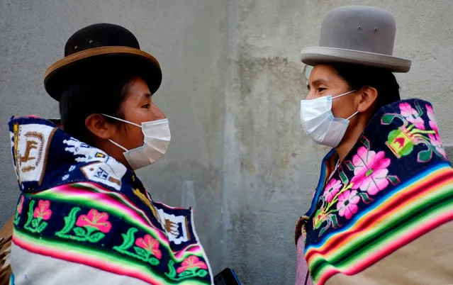 Aymara women from Huachacalla wearing face masks wait for a meeting at the La Casa Grande del Pueblo after the election day in La Paz, Bolivia, October 20, 2020. (Photo by David Mercado/Reuters)