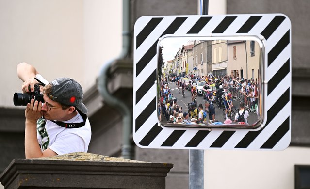Reflection in a mirror of a general view of the peloton competing prior to the 112th Tour de France 2025, Stage 10 a 165.3km stage from Ennezat to Le Mont-Dore Puy de Sancy (Super Sancy) 1318m / #UCIWT / on July 14, 2025 in Ennezat, France. (Photo by Tim de Waele/Getty Images)