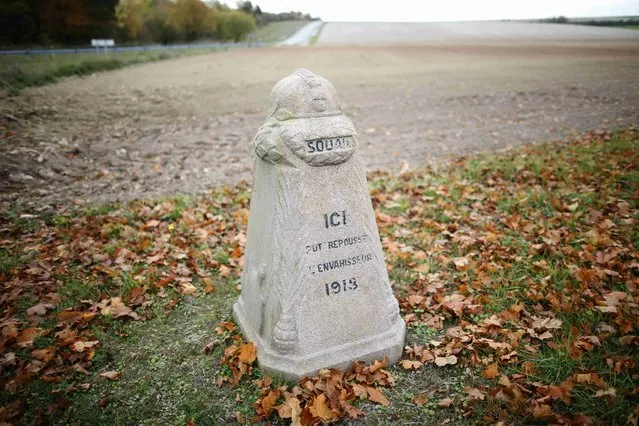 A "Borne du front" (Demarcation stone) with a helmet capping the milestone is seen near the entrance of Camp de Suippes, near Reims, France, November 3, 2015. A total of 118 markers were erected (22 in Belgium, 96 in France) in the years between 1921-1927 by French sculptor Paul Moreau-Vauthier to create a line of small monuments to be located along the line on the Western Front which was the furthest point to which the German Army had penetrated into France. The milestone reads "Here in 1918 at Souan the invader was pushed back". (Photo by Charles Platiau/Reuters)