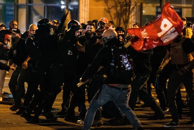Members of Antifa and Proud Boys clash in the middle of the street following the “Million MAGA March” on November 14, 2020 in Washington, DC. Various pro-Trump groups gathered in DC today for the “Million MAGA March” to protest the results of the 2020 presidential election. (Photo by Samuel Corum/Getty Images)