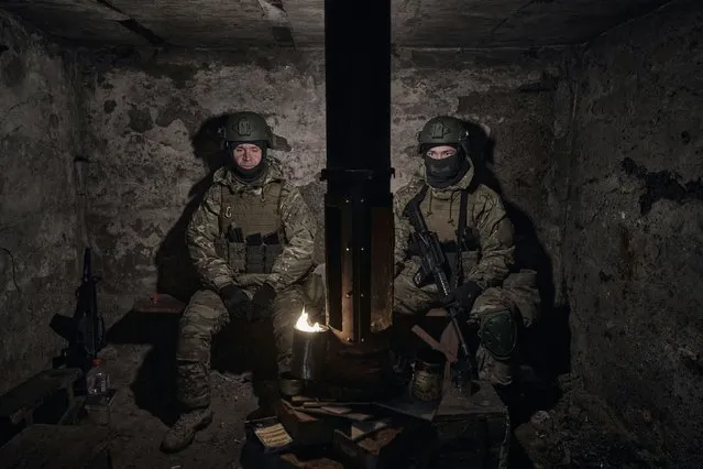 Volunteer soldiers rest in a shelter on their positions close to Bakhmut, Donetsk region, Ukraine, Wednesday, March 8, 2023. (Photo by Libkos/AP Photo)