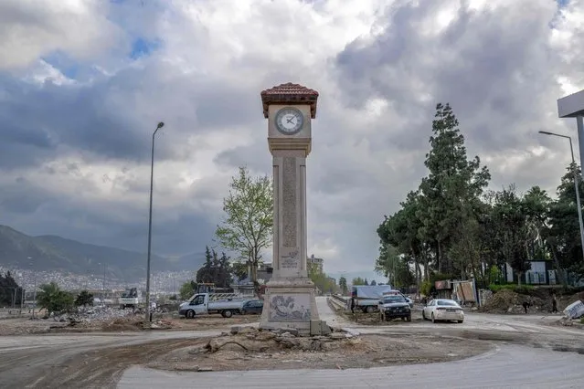 This photograph shows a clock tower of Hatay still standing as it stopped at 4:10 in Hatay on March 28, 2023, after a 7.8-magnitude earthquake on February 6, 2023 killed more than 50,000 in southeastern Turkey and nearly 6,000 over the border in Syria, leaving entire cities in ruins. Hundreds of thousands of workers in Turkey and Syria have lost their livelihoods due to the earthquake, the United Nations said on March 28, 2023, as it called for urgent support to rebuild businesses. (Photo by Bulent Kilic/AFP Photo)