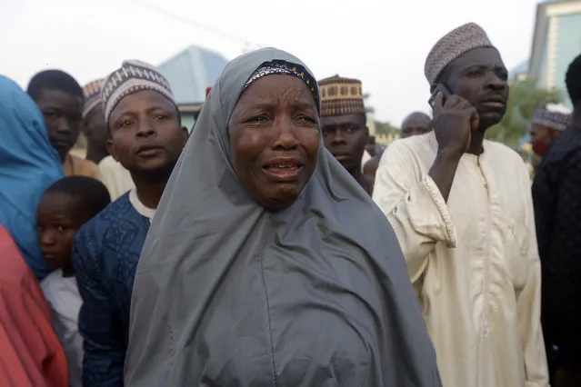 A family member of a freed schoolboy cries as she waits for a reunion with her son in Katsina Nigeria Friday December 18, 2020. More than 300 schoolboys kidnapped last week in an attack on their school in northwest Nigeria have arrived in the capital of Katsina state to celebrate their release. The boys were abducted one week ago from the all-boys Government Science Secondary School in Kankara in Katsina state village. (Photo by Sunday Alamba/AP Photo)