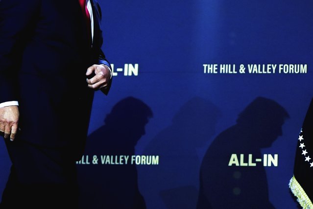 President Donald Trump walks to sign executive orders during an artificial intelligence summit at the Andrew W. Mellon Auditorium, Wednesday, July 23, 2025, in Washington. (Photo by Julia Demaree Nikhinson/AP Photo)