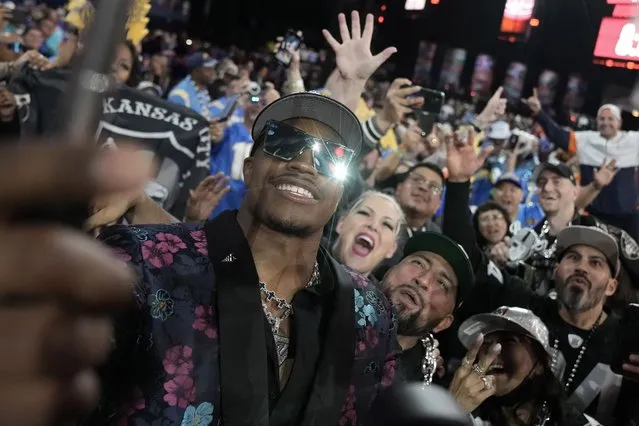 Texas Tech defensive lineman Tyree Wilson takes a selfie with fans after being chosen by the Las Vegas Raiders with the seventh overall pick during the first round of the NFL football draft, Thursday, April 27, 2023, in Kansas City, Mo. (Photo by Charlie Riedel/AP Photo)