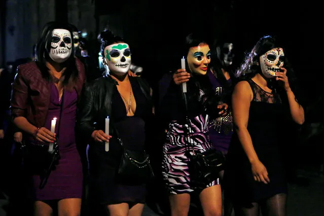 People wear skeleton masks during a procession organized by s*x workers to remember their deceased colleagues, especially those who were violently murdered, as part of the celebrations ahead of the Day of the Dead, in Mexico City, Mexico October 28, 2016. (Photo by Ginnette Riquelme/Reuters)
