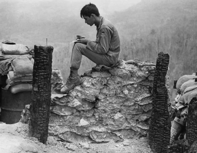 A South Vietnamese soldier steals a few moments of solitude to write a letter seated atop a sandbagged position on Firebase 6 in Vietnam on May 5, 1971. (Photo by Nick Ut/AP Photo)