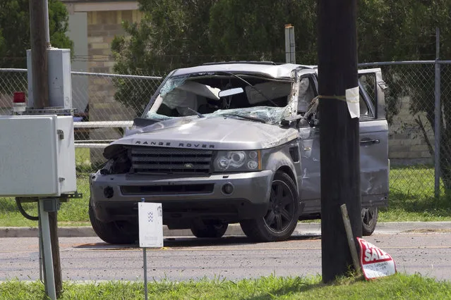 Emergency personnel take away a damaged vehicle after a fatal collision in Brownsville, Texas, Sunday, May 7, 2023. Several migrants were killed after they were struck by a vehicle while waiting at a bus stop near Ozanam Center, a migrant and homeless shelter. (Photo by Michael Gonzalez/AP Photo)