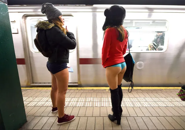 Some participants in the No Pants Subway Ride wait for a train in their underwear in New York subway on January 11, 2015 in New York. The No Pants Subway Ride is an annual which was started in 2002 by Improv Everywhere in New York, the goal is for riders to get on the subway train dressed in normal winter clothes without pants and keep a straight face. (Photo by Timothy A. Clary/AFP Photo)