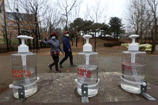 Bottles of hand sanitizer are displayed for use at a park in Goyang, South Korea, Friday, January 22, 2021. South Korea is reporting its smallest daily increase in coronavirus infections in two months as officials express cautious hope that the country is beginning to wiggle out from its worst wave of the pandemic. (Photo by Ahn Young-joon/AP Photo)