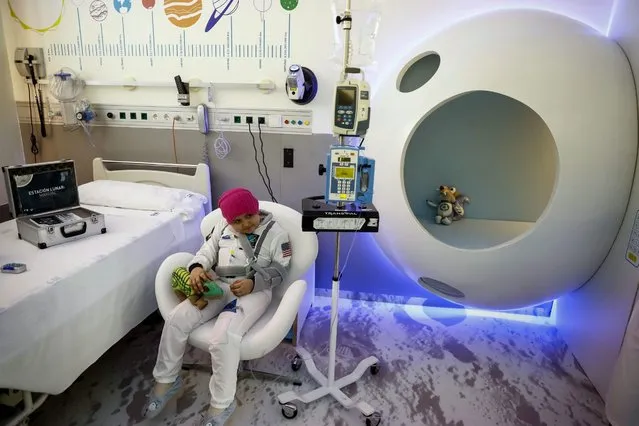 A girl suffering from cancer poses in a isolated room recreating a space station during its inauguration at the Gregorio Maranon Hospital's children oncology unity in Madrid, Spain, 02 November 2016. The room offers an interactive and educational experience to children with cancer. (Photo by Emilio Naranjo/EPA)