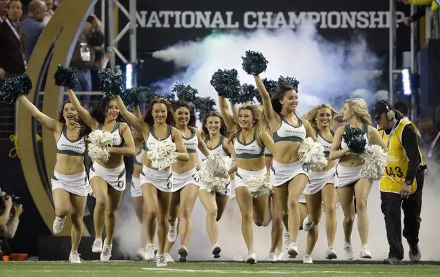 Oregon cheerleaders take the field before the NCAA college football playoff championship game against Ohio State Monday, January 12, 2015, in Arlington, Texas. (Photo by L. M. Otero/AP Photo)