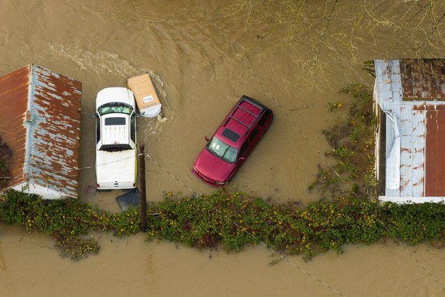 A drone view shows vehicles in an area flooded by the Snoqualmie River in Fall City, Washington, on December 9, 2025. (Photo by David Ryder/Reuters)